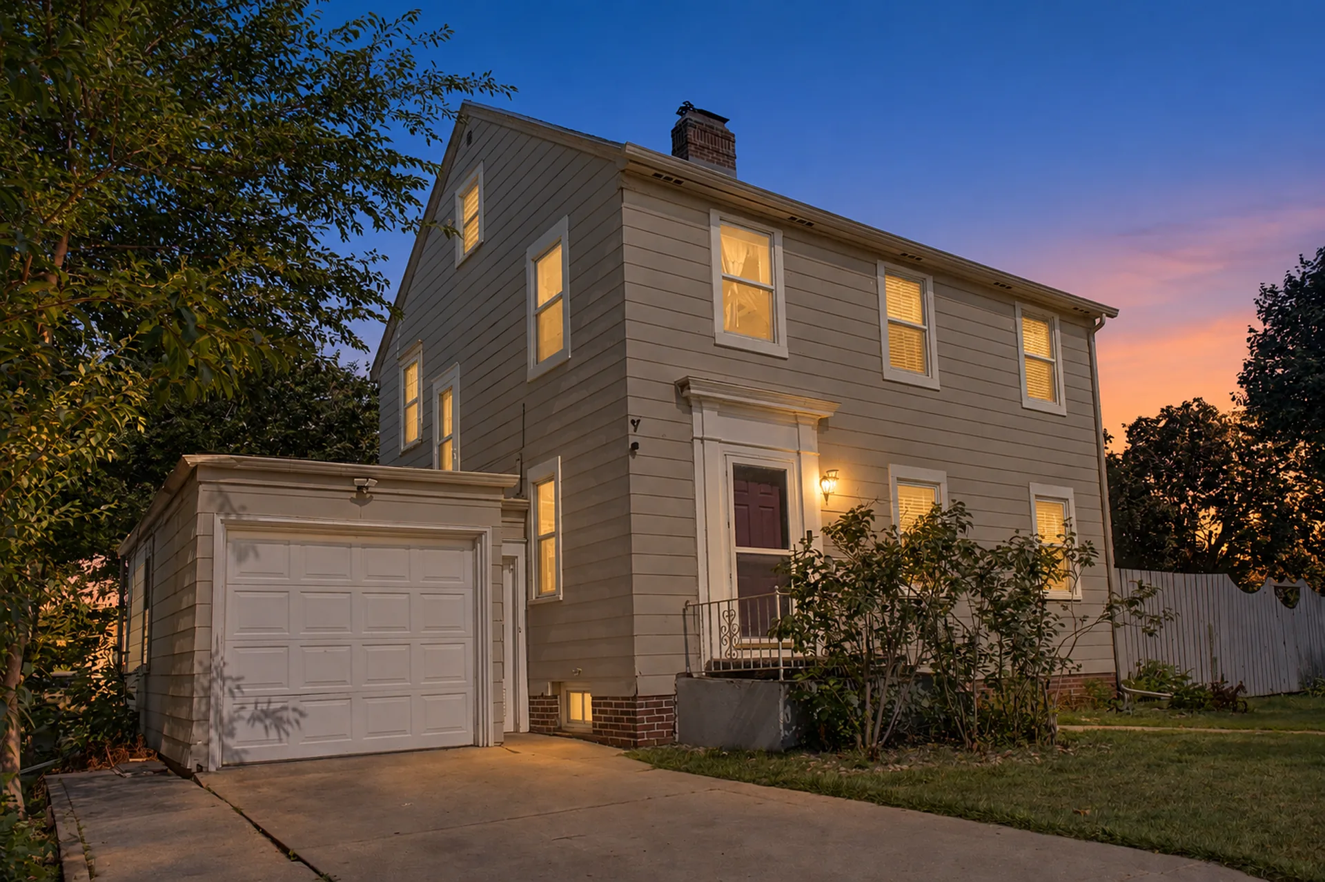 The same entry and garage corner of 608 9th Street, Worthington, edited into a virtual twilight